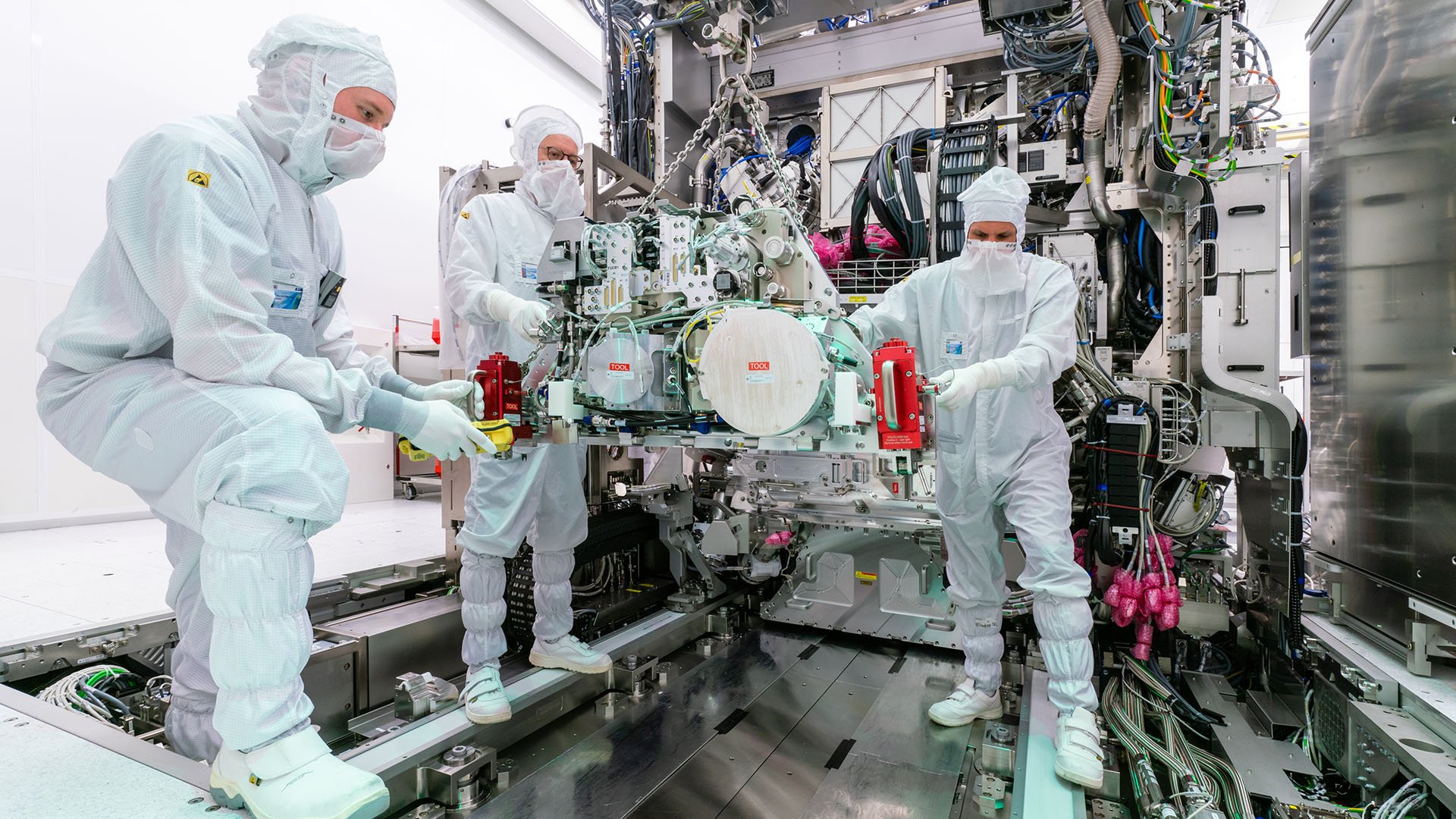 Engineers working in a semiconductor cleanroom environment